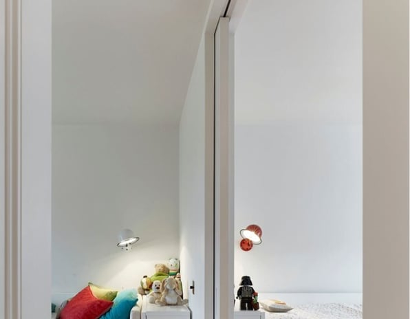 Floor-to-ceiling pocket doors separating two modern rooms while maintaining an open, spacious feel.